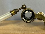 a small telescope that is sitting on a wooden table