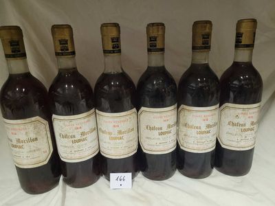 six bottles of wine are lined up in a row on a table