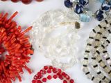 a lot of beads and bracelets on a table