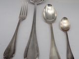 four spoons and a fork on a table