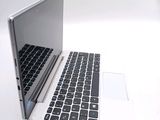 a white laptop with a black keyboard sitting on a table