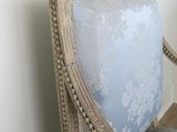 a blue and white chair in a room with a white wall