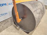 a close up of a large metal drum on a stand