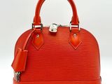 a close up of a red handbag on a white background
