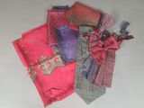 several different colored ties are laid out on a white surface