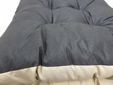 a black and white pillow that is on a bed