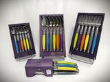 a set of spoons and forks in a purple box