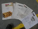 a person standing next to a pile of papers on the ground