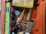 une valise pleine d'objets posée par terre