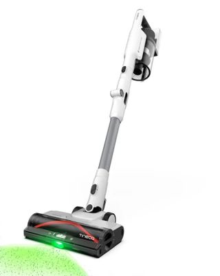 a close up of a vacuum and a green ball on a white surface