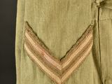 a close up of a military uniform with a chevroned patch on the chest