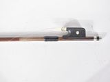 a fishing rod with a wooden handle on a white surface