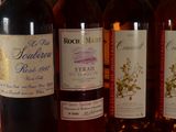 several bottles of wine are lined up on a table