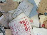 a pile of old letters and envelopes on the floor