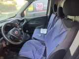 the interior of a car with a seat covered in a blue blanket