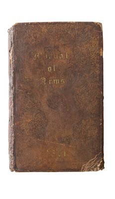 an old book with writing on it sitting on top of a white surface