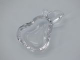 clear glass heart shaped dish with a handle on a white surface
