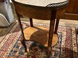 a small table with a marble top on a rug