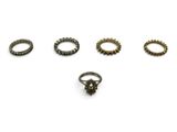 a set of five rings with different designs on a white background