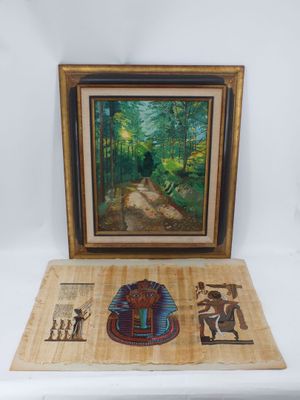 une image représentant une photo d'un tableau posé sur une table à côté d'une œuvre d'art