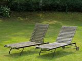 two lawn chairs that are sitting in the grass