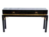 une console noire et dorée à deux tiroirs
