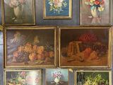 many pictures of fruit and flowers displayed on the wall