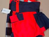 men ' s clothing in a cardboard box with a tag on it