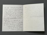 an open book with a handwritten letter on it