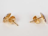 a pair of gold stud earrings on a white surface