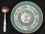 a plate with a spoon and a spoon rest on a table