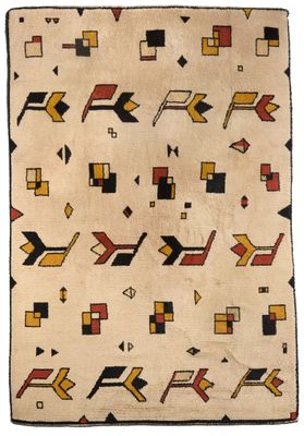 un vieux tapis navajo orné de motifs géométriques sur fond blanc