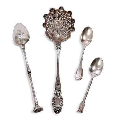 three spoons and a spoon rest on a white surface