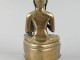 an image of a statue of a person sitting on top of a table