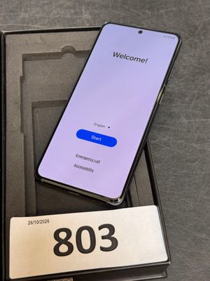 an open box with a phone in it sitting on top of a table