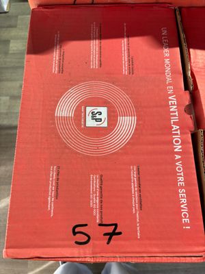 boxes of pizza sitting on a table with a person standing in front of them