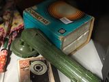 a green object on the table next to a book and a green object