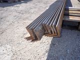 several pieces of steel are stacked on top of each other in the dirt