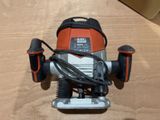 a black and decker router on a table with a cord