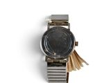 a close up of a wrist watch on a white surface