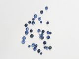 a group of blue sapphires on a white surface