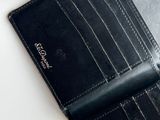 a black wallet sitting on top of a white table