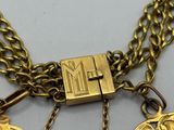 two gold necklaces with a coin and a padlock on a chain