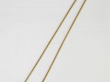 un collier en or avec une chaîne sur fond blanc