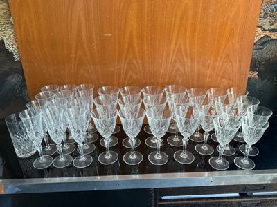a lot of wine glasses sitting on a table