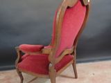 a red chair that is sitting on the carpet