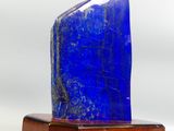 a blue stone on a wooden base on a white background