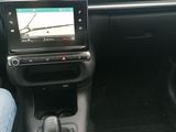 someone is sitting in the driver ' s seat of a car with their feet on the steering wheel