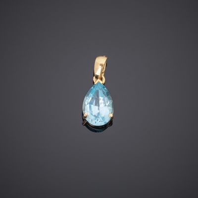 an aqua blue topaze tear shaped pendant on a black background