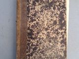 un vieux livre posé sur une table blanche